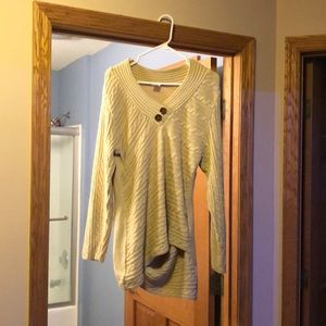 Very cute tunic sweater with cross cross design at the bottom.  Cream/beige.
